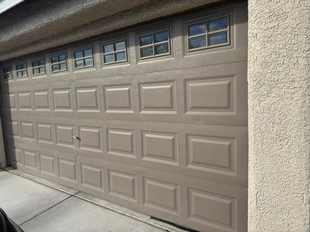 Sun-exposed beige garage door on a Las Vegas home