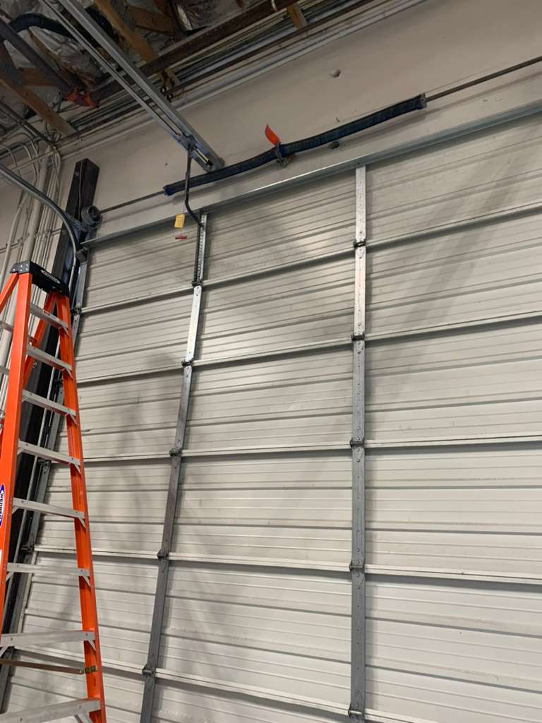 Ladder next to a garage door