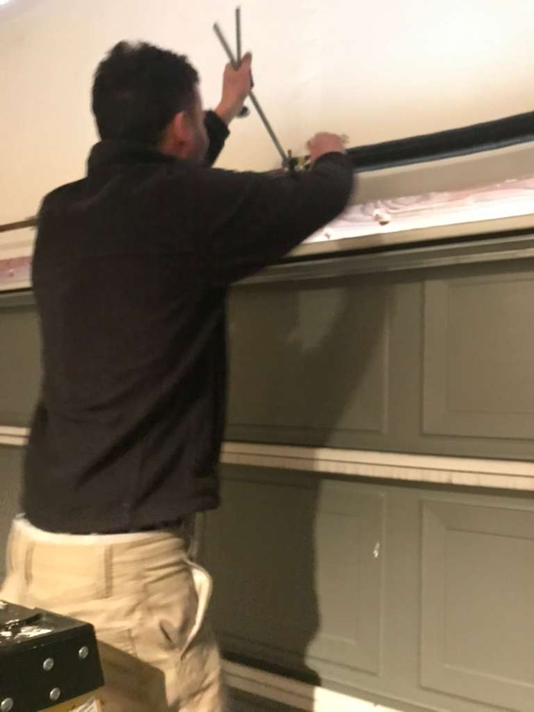Technician working at a garage door panel