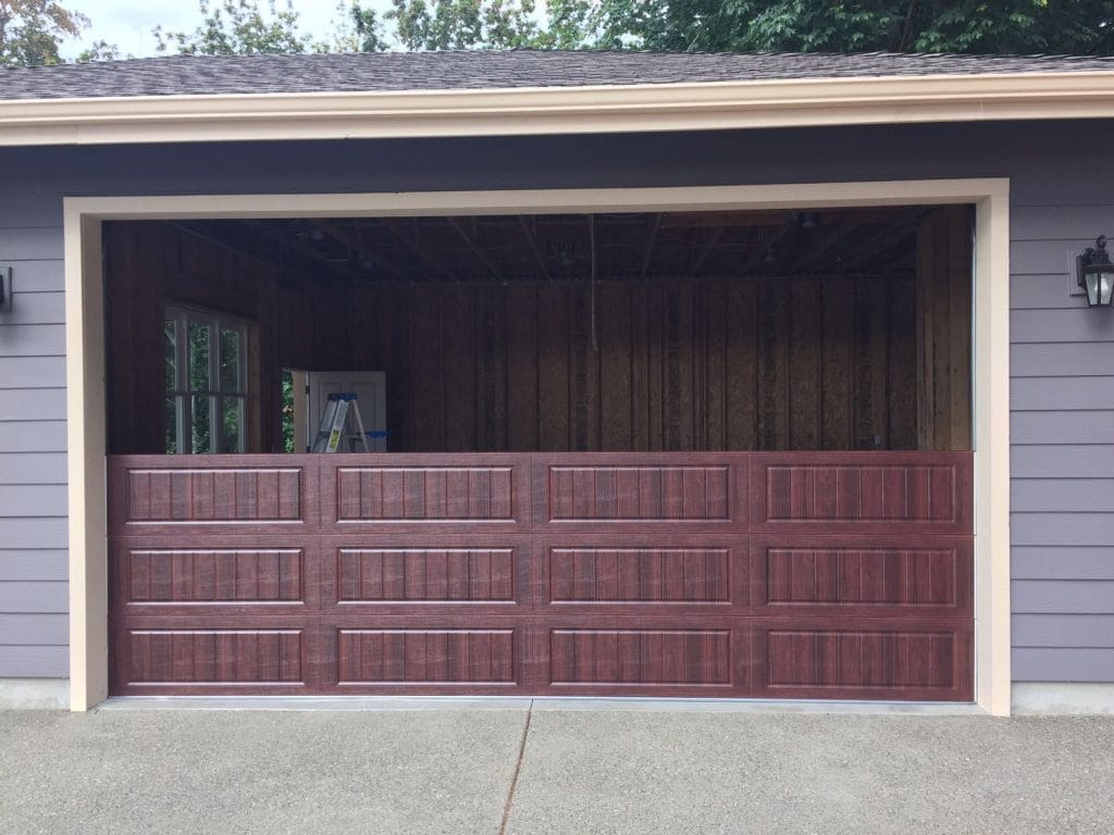 Newly installed maroon garage door on a Las Vegas home