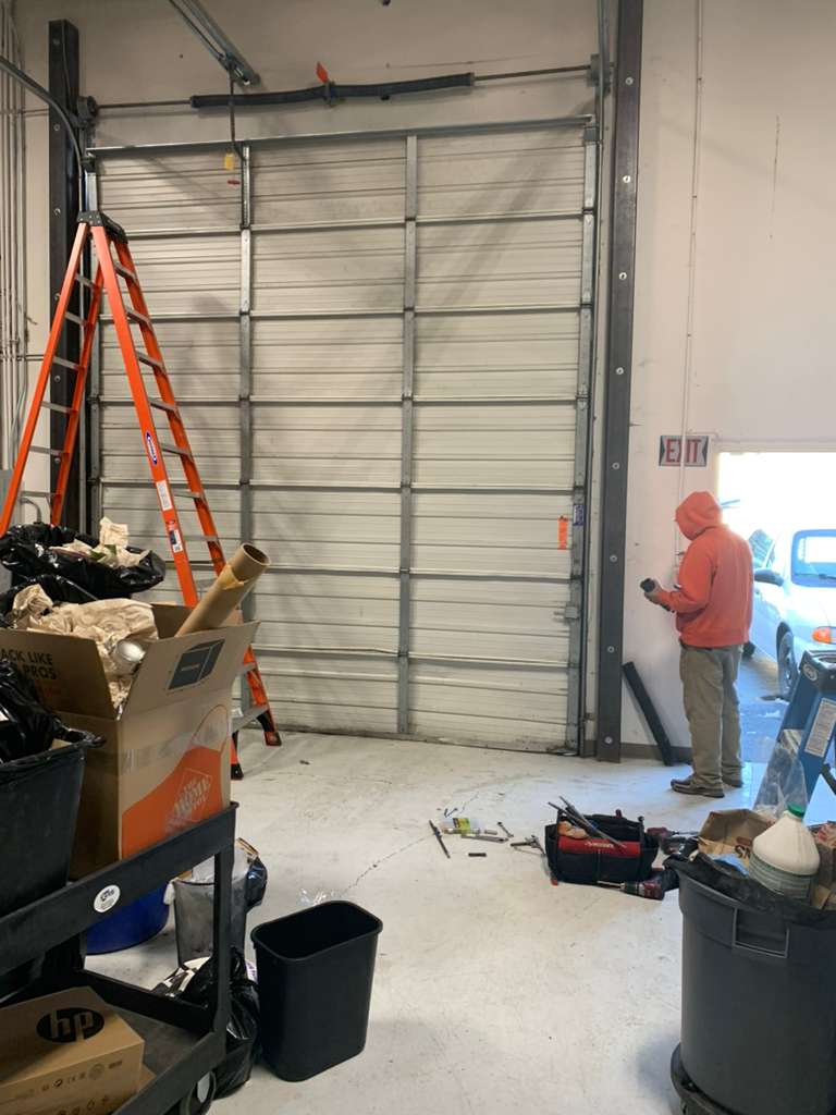 A1 Local Garage Door technician with a ladder at a Las Vegas garage